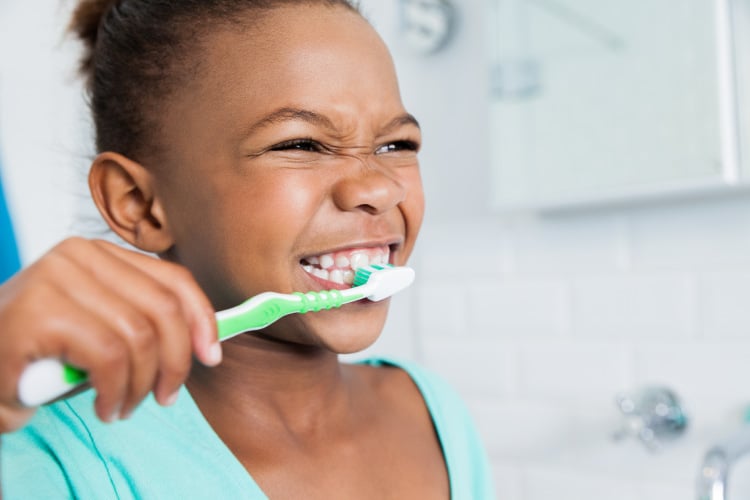 girl brushing her teeth